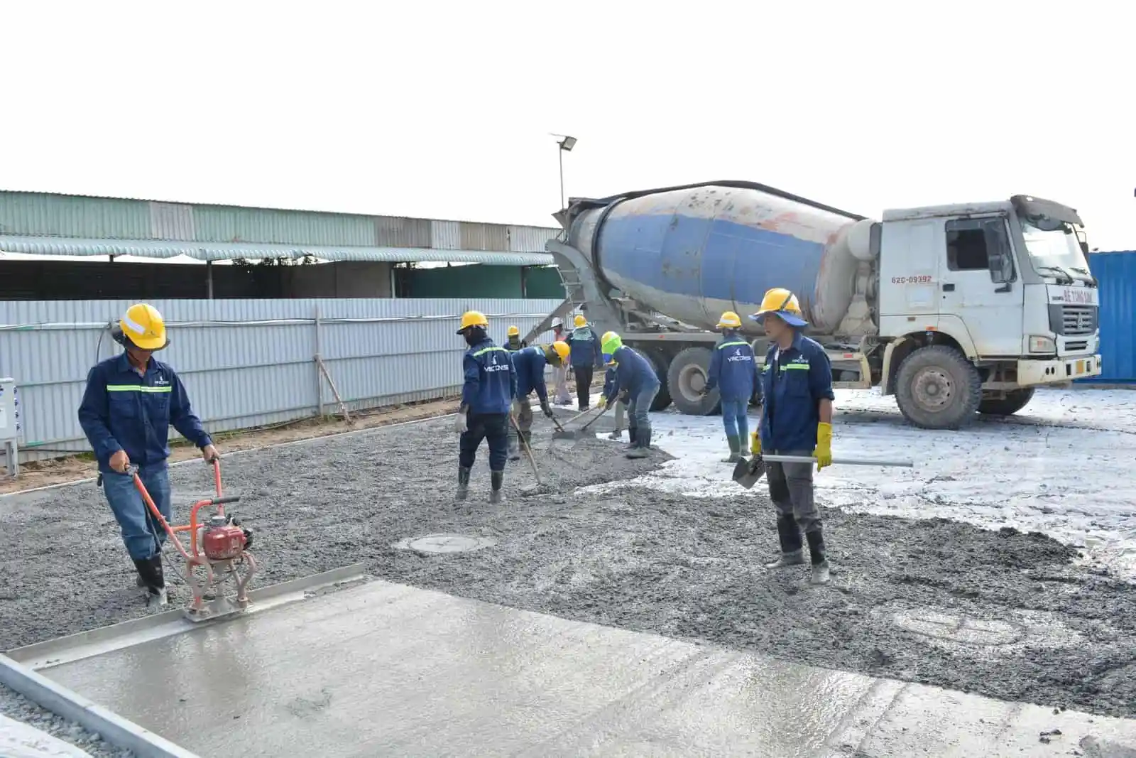 Concrete being placed and levelled on a construction site